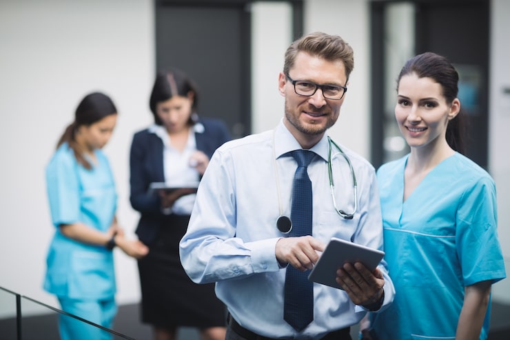 Doctor and nurse reviewing records on a tablet